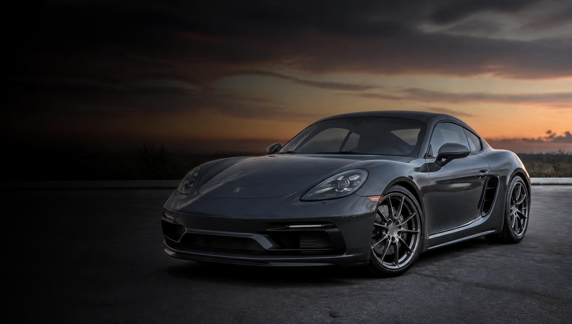 Freshly detailed dark grey sports car with flawless paint photographed at dusk